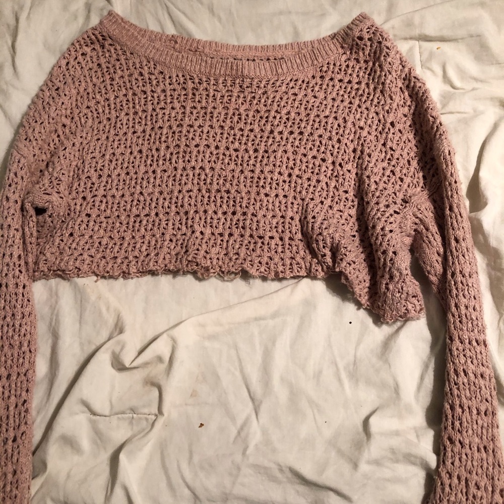 A pink American eagle long sleeve with holes in